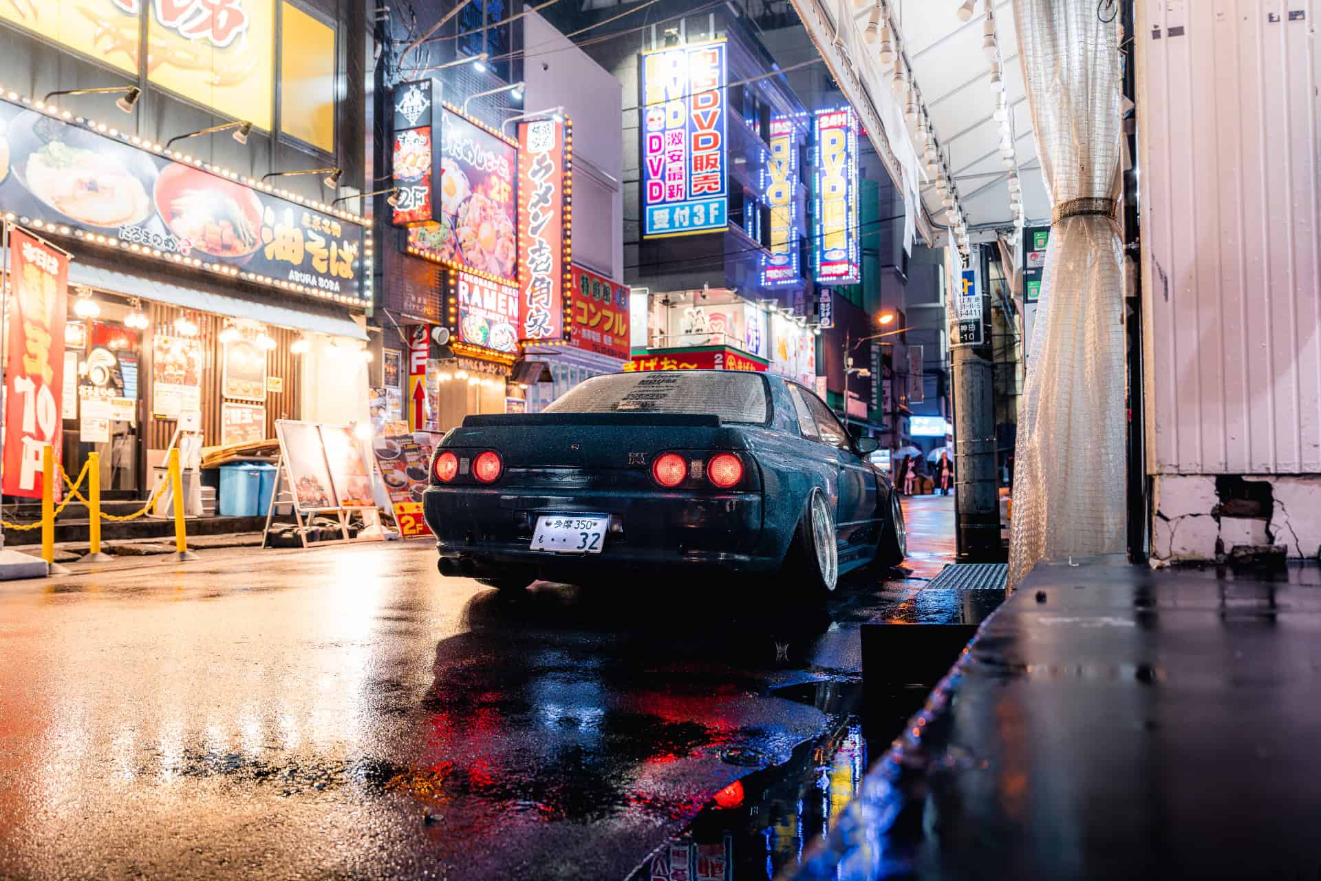 Nissan Skyline R32 on a wet Tokyo street at night, graded with an LM preset