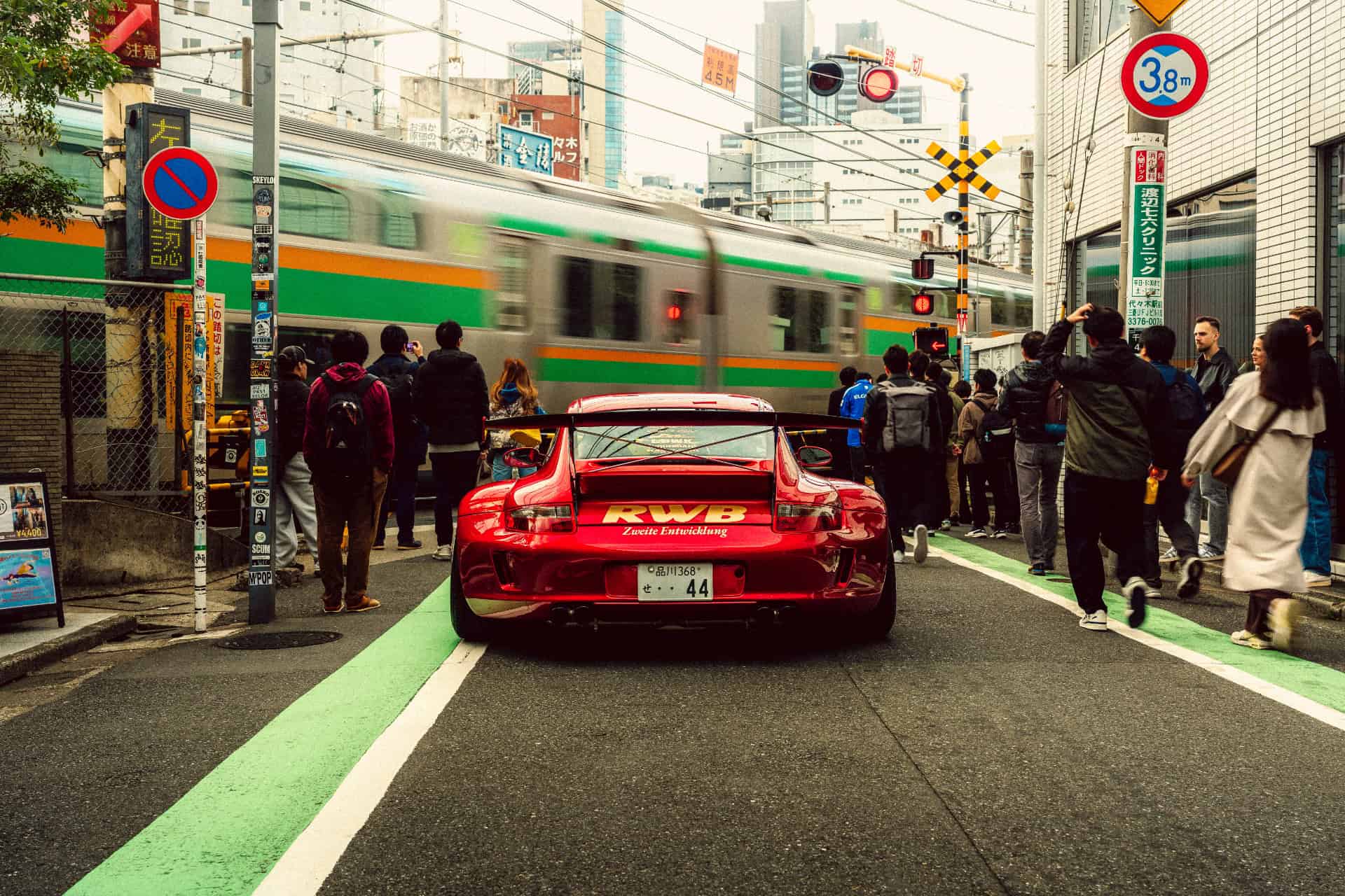 The same RWB 911 at a Tokyo level crossing, graded with an LM preset